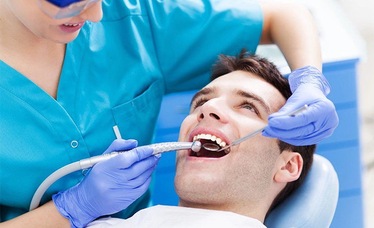 A skilled dentist offers advanced dental treatment using modern tools for safe, painless oral care.